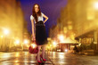 Photo: Female model posing on lighted sidewalk at night Female model posing on lighted sidewalk at night