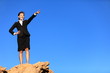 Business concept - businesswoman pointing at future ahead
