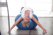 Woman balansing on the ball at the gym