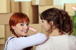 two girlfriends moving into a new apartment