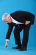 mature businessman pointing et something on floor