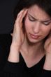 Woman suffering from a throbbing headache