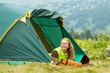 tourist in front camp tent