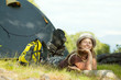 Happy  tourist in front camp tent