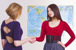 Pretty travel agent greets client with handshake