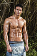 male model with muscles on the countryside