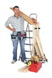 craftsman holding a wooden floor board