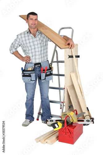 Photo: craftsman holding a wooden floor board craftsman holding a wooden floor board