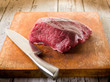 meat with knife over cutting board