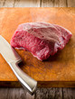 meat with knife over cutting board