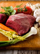 meat with vegetables ingredients over cutting board