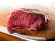 meat with knife over cutting board