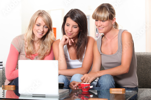 Photo: Young women watching a film on a laptop Young women watching a film on a laptop