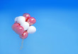 red and white balloons in the sky