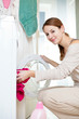 Housework: young woman doing laundry