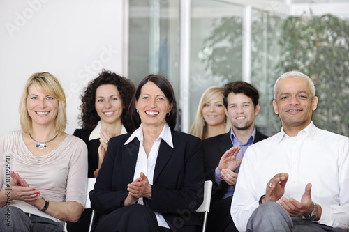 Photo: Business team applauding after a conference Business team applauding after a conference