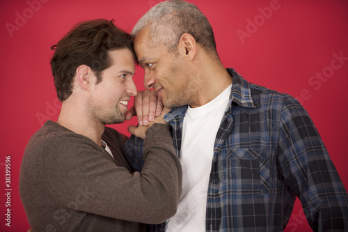 Photo: Gay couple on red background Gay couple on red background