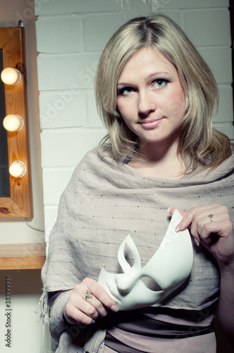 Photo: Elegant caucasian blonde with white face mask, studio shot Elegant caucasian blonde with white face mask, studio shot