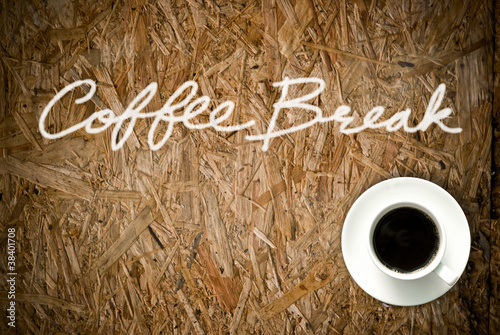 Photo: Coffee cup on grunge wood table Coffee cup on grunge wood table