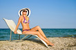 The girl in a hat having a rest on seacoast The girl in a hat having a rest on seacoast