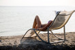 The girl in a hat having a rest on seacoast The girl in a hat having a rest on seacoast