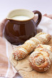 A jug with milk and lye pastry on the wooden board, selective fo A jug with milk and lye pastry on the wooden board, selective fo