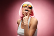 Young girl in pink wig posing on a pink background