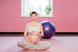 Young pregnant woman doing pregnancy yoga