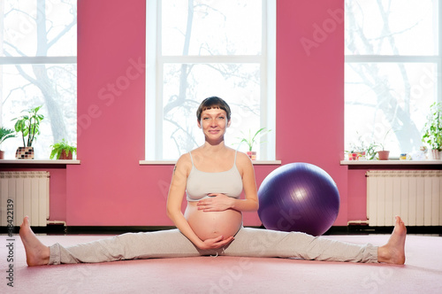 Photo: Young pregnant woman doing pregnancy yoga Young pregnant woman doing pregnancy yoga