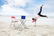 Happy Asian businessman on beach