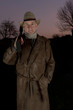 man with cowboy hat, long leather coat and riot gun