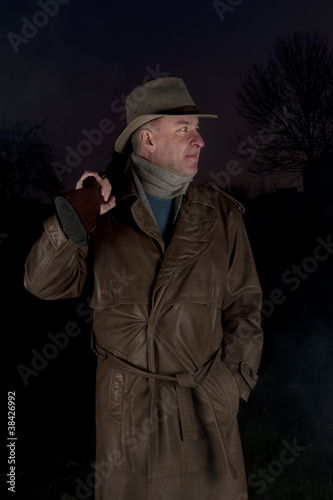 Photo: man with cowboy hat, long leather coat and riot gun man with cowboy hat, long leather coat and riot gun