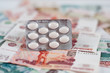 Tablets in a blister on the background of the money Tablets in a blister on the background of the money