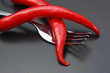red chili peppers and knife on the kitchen table