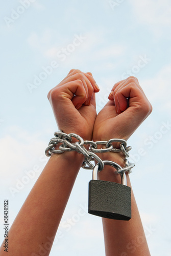 Photo: Hands tied up with chains Hands tied up with chains
