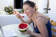 Young woman eating watermelon