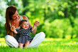 Photo: Mother and daughter on the green grass Mother and daughter on the green grass