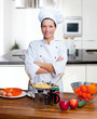 Photo: Chef woman portrait in the kitchen Chef woman portrait in the kitchen