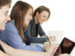 Foto: Three young students learning with touchpad and books Three young students learning with touchpad and books