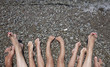 Family feet on the rocky beach (sea wave coming) Family feet on the rocky beach (sea wave coming)