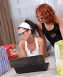 Two pretty girls shopping over internet