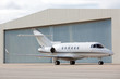 Photo: Airplane in front of hangar Airplane in front of hangar