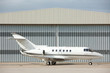 Photo: Airplane in front of hangar Airplane in front of hangar