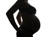 Pregnant woman in backlight white barkground