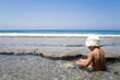 little boy plays on an ocean coast in summer day little boy plays on an ocean coast in summer day