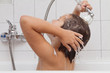A little girl taking a bath by her own