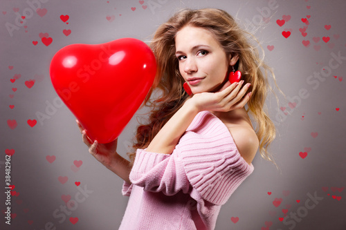 Photo: Valentines day woman holding red heart balloon Valentines day woman holding red heart balloon