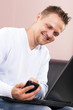 Young businessman comfortable on the couch, working.