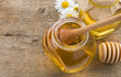 glass jar of honey and stick on wood glass jar of honey and stick on wood