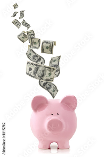 Photo: Money Falling into Piggy Bank Money Falling into Piggy Bank